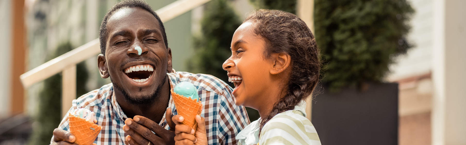 Father and child eating ice cream